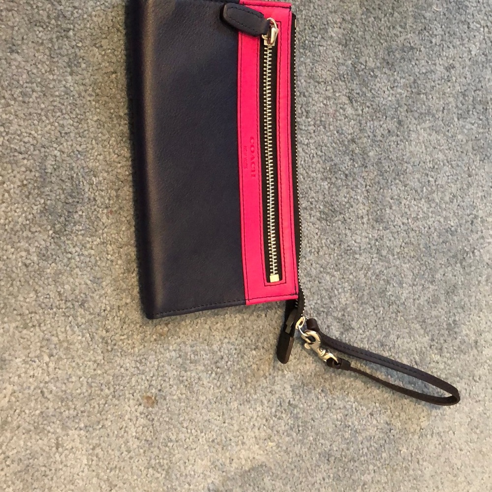 Coach wristlet. Navy leather with pink.  Many slots for cards inside !